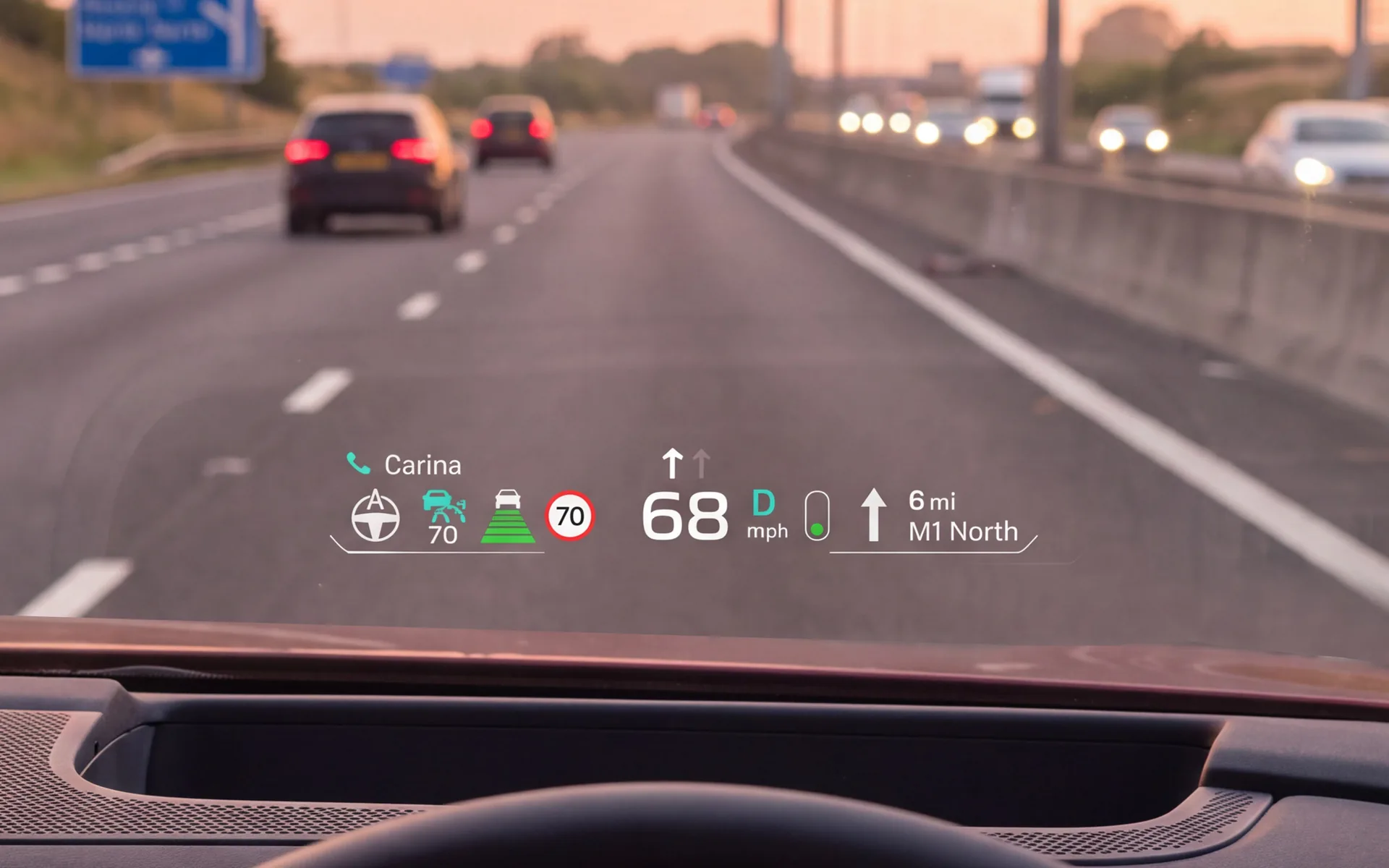 Driving at dusk with the head-up display on the windscreen showing speed, limit, navigation and an incoming call